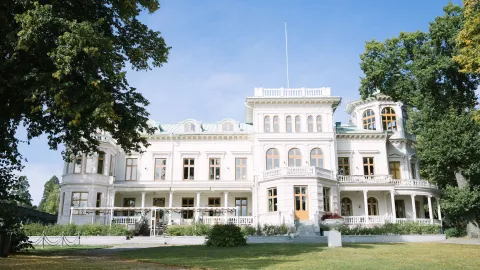 Vit ståtlig byggnad i en park